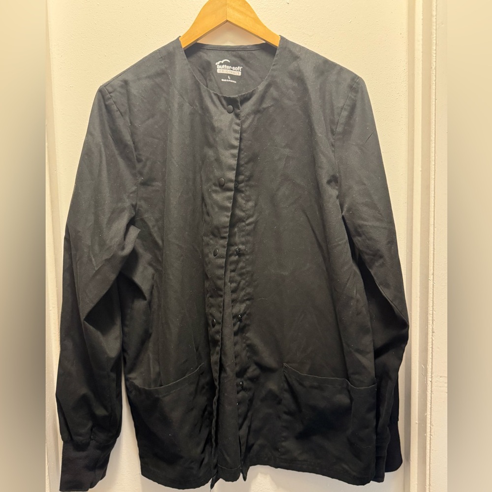 UA Butter-soft black lab coat size Large. Snap closure, needs a lint brush.